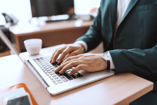 man typing laptop